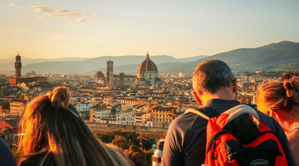 People admire the florence skyline at sunset